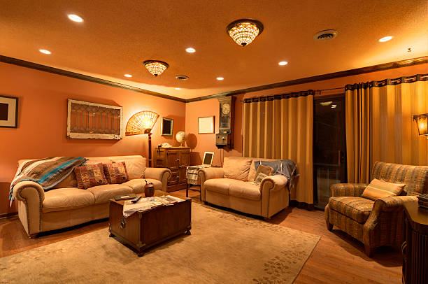 Traditional Indian living room with brass hanging lamps and decorative ceiling fan with lights