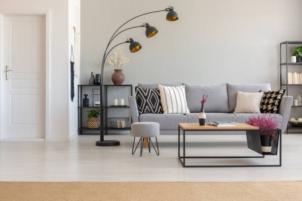 Contemporary living room with arc floor lamp beside sofa and table lamp on side table
