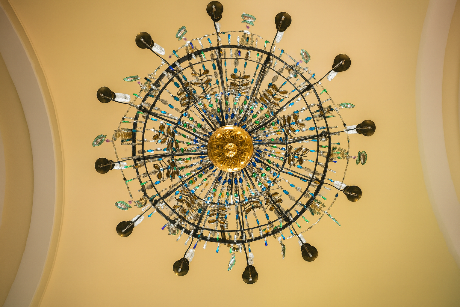 Luxury living room with modern crystal chandelier and gold wall sconces