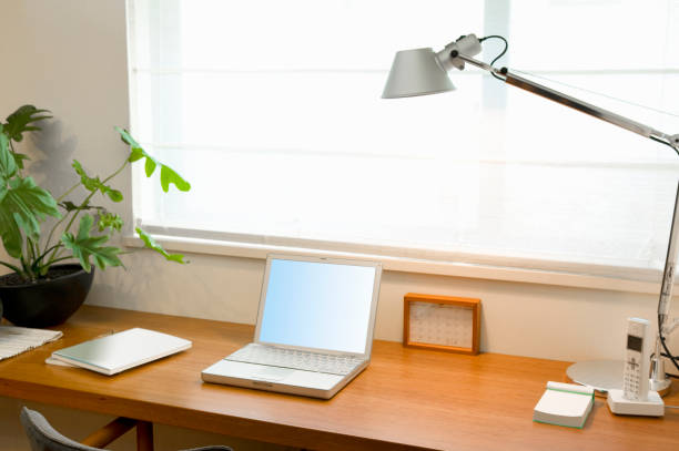 Employee adjusting desk lighting brightness via control panel