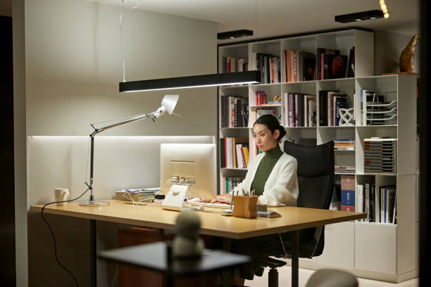 Employee working under tunable white LED lighting in office