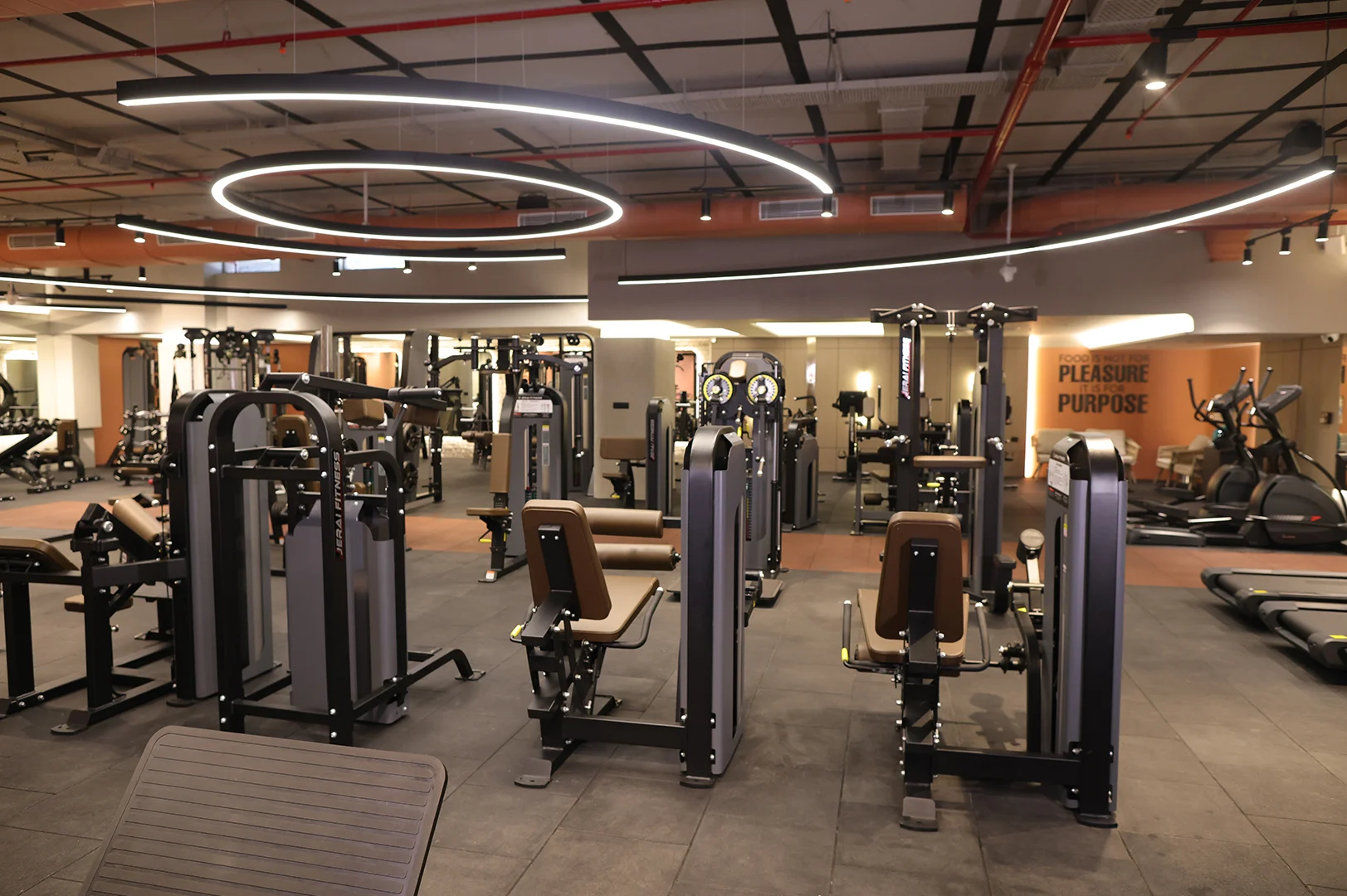 Commercial lighting design for gym and fitness studio with modern ceiling fixtures